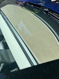Interior view of a Tesla vehicle showing the dashboard with a carpeted dash mat in a neutral color, designed to protect the dash from UV radiation and heat.