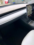 Interior view of a Tesla vehicle showing the dashboard with a carpeted dash mat in a neutral color, designed to protect the dash from UV radiation and heat.